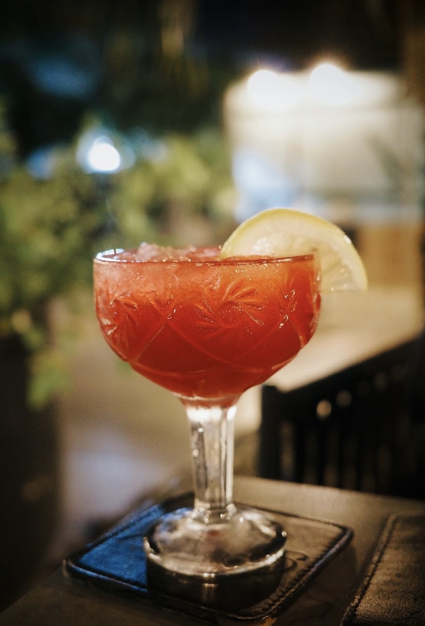 Red cocktail in a cut-glass coupe at Bold Restaurant Ghana