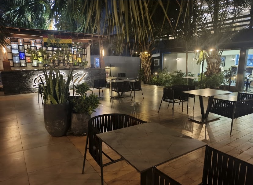Outdoor patio with tables and the Bold bar in the background